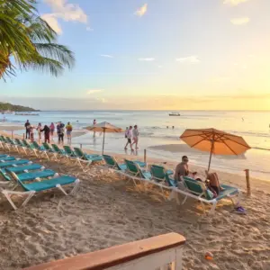 West Bay Beach in Roatan at sunset with beach chairs and umbrellas